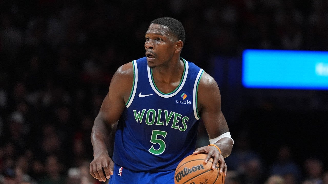 Anthony Edwards, Minnesota Timberwolves star, dribbles basketball on court during a game.